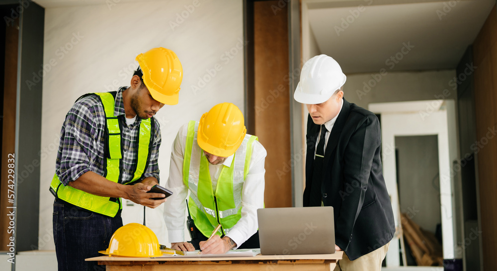 Architect caucasian man working with colleagues mixed race in the construction site. Architecture en