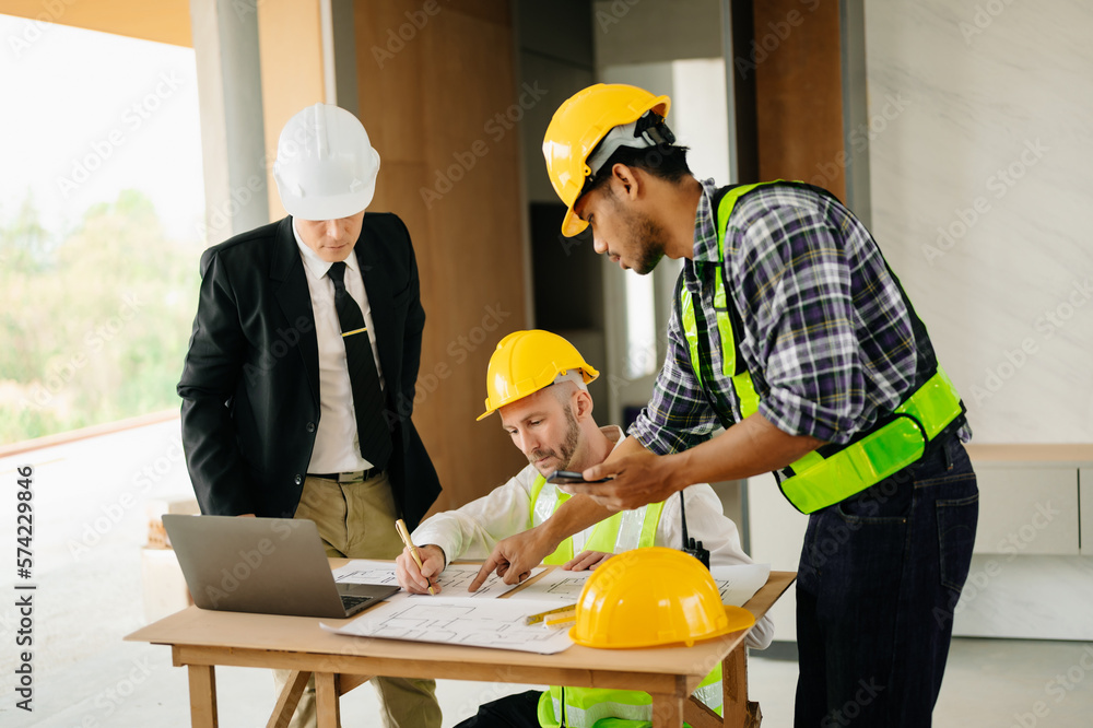 Architect caucasian man working with colleagues mixed race in the construction site. Architecture en