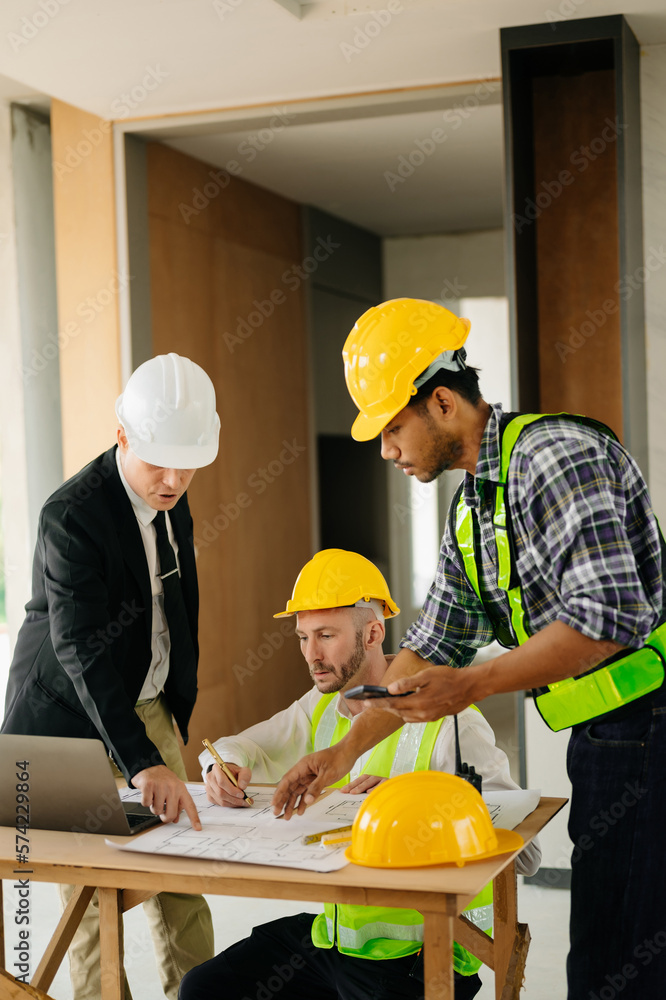 Architect caucasian man working with colleagues mixed race in the construction site. Architecture en