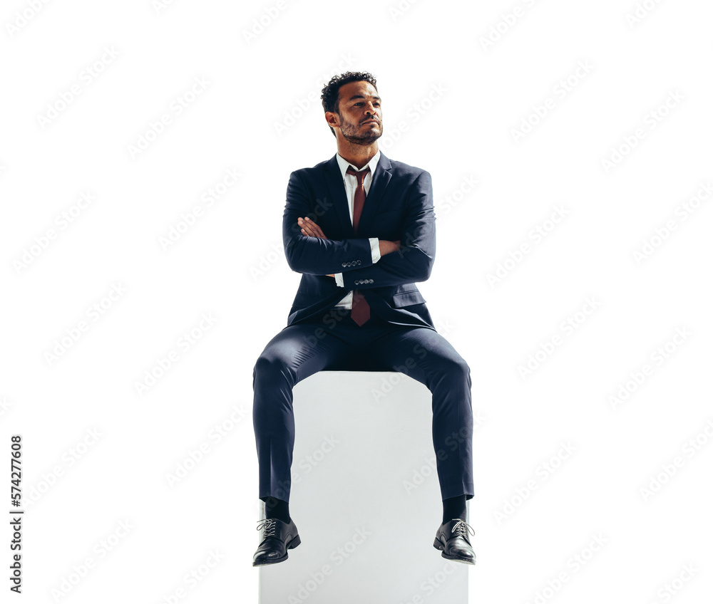 Thoughtful businessman sitting on top of a block on a transparent background