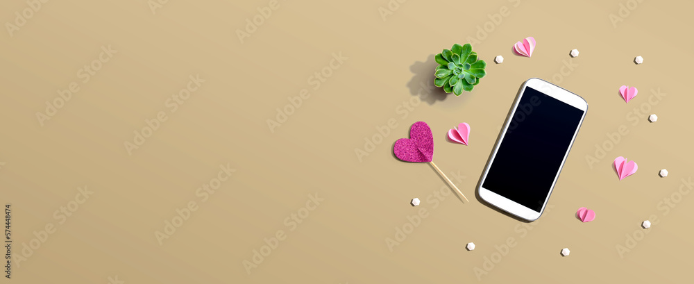 Smartphone with hearts and a succulent - flat lay