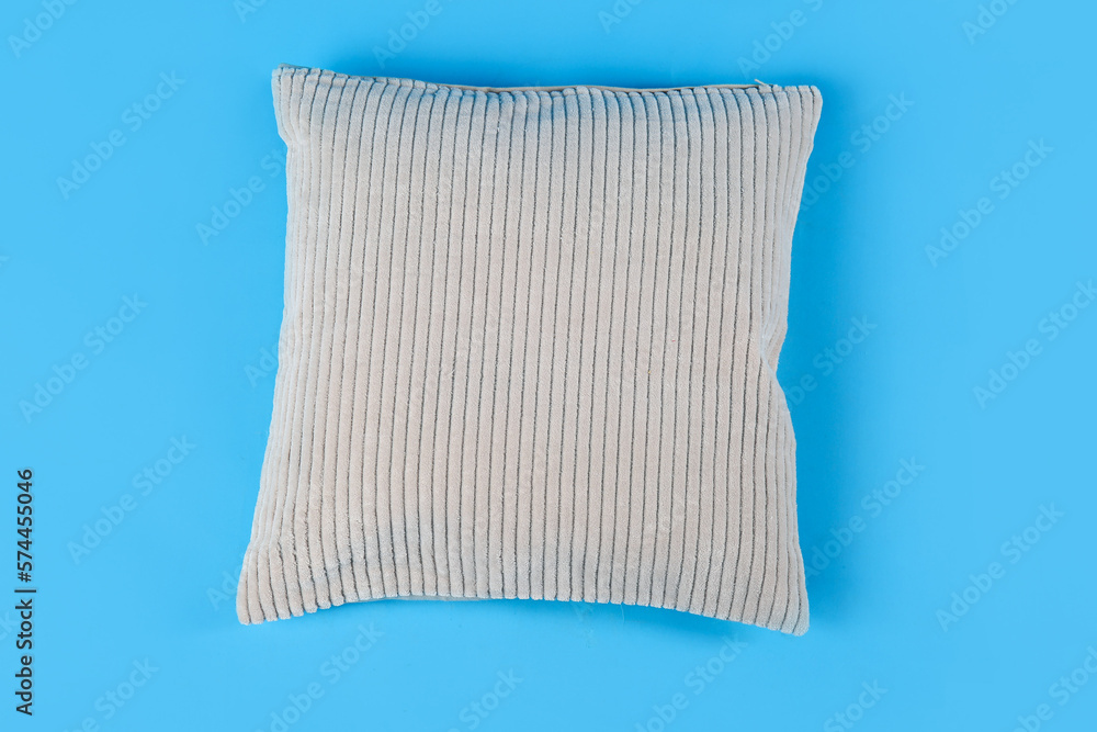 Soft pillow on blue background