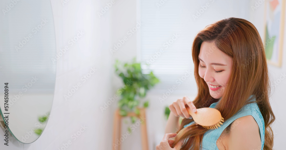 woman is brushing hair