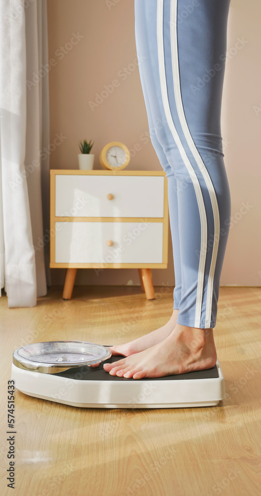 woman measure weight on scale