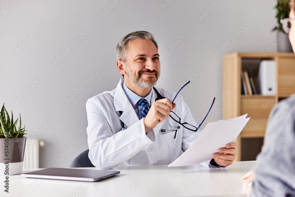 The doctor and patient talk about the treatment, sitting at the hospital.