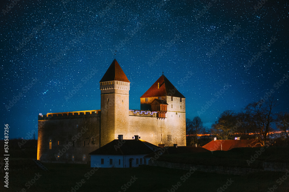 Kuressaare, Saaremaa Island, Estonia. Amazing Starry Sky Above Episcopal Castle In Night Time. Tradi