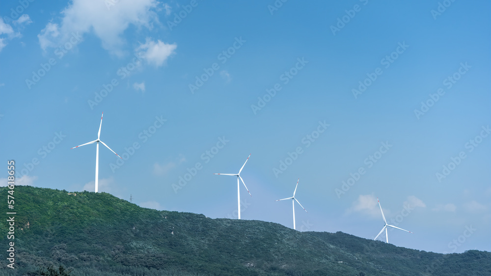 Wind power generation windmills lined up on the mountain. Aerial view.