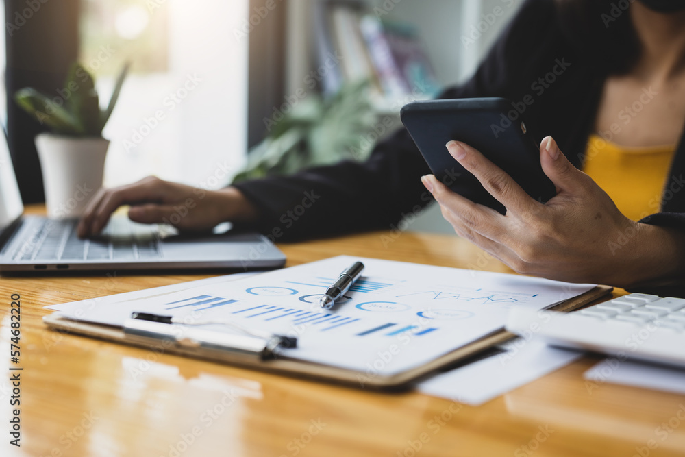 Financial consultant, businesswoman planning finances and analyzing accounting on modern smartphone.