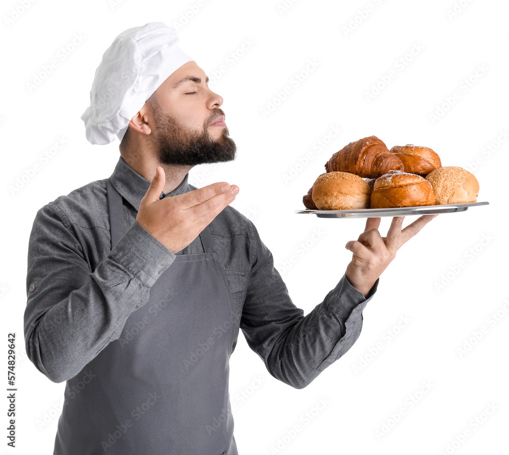 Male baker holding tray with pastries on white background