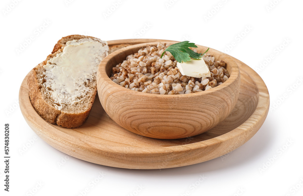 Wooden bowl of tasty buckwheat porridge with butter, bread and dill isolated on white background