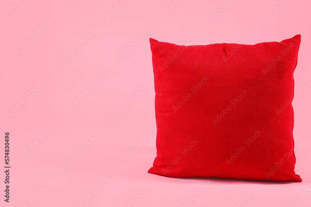 Red pillow on pink background