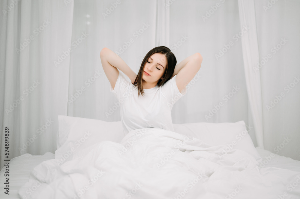 Image of beautiful woman resting in white bed at bedroom. in morning . Lifestyle at home concept.