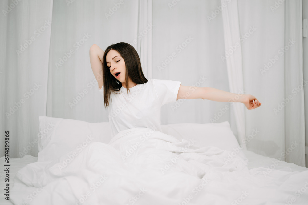 Image of beautiful woman resting in white bed at bedroom. in morning . Lifestyle at home concept.