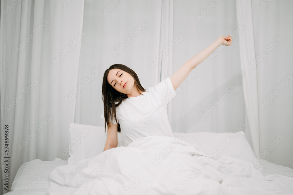 Image of beautiful woman resting in white bed at bedroom. in morning . Lifestyle at home concept.