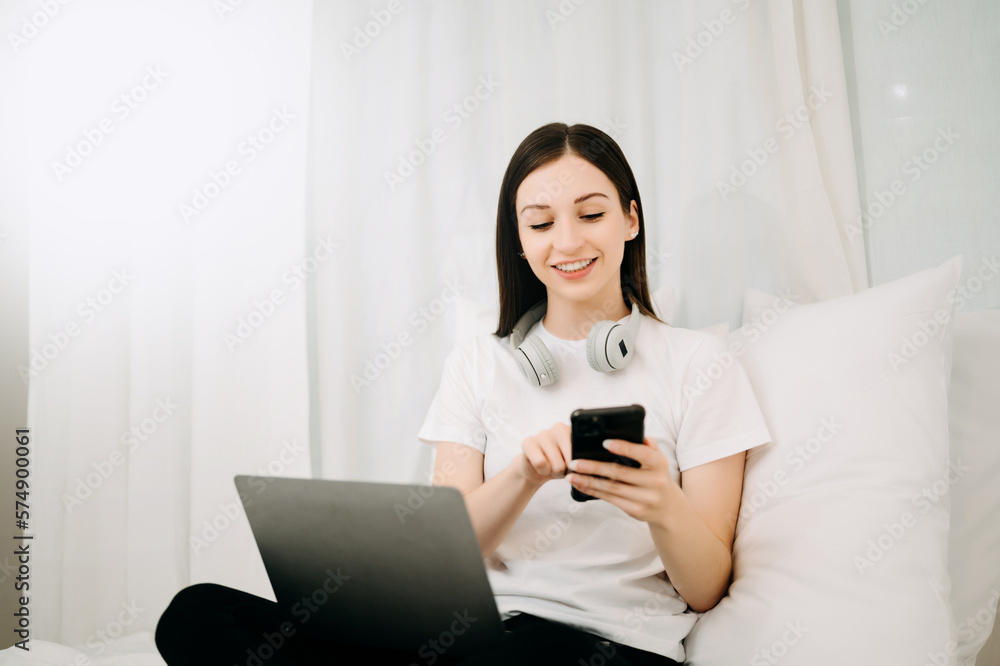 Beautiful woman has woken up on a white bed and holding coffee in the morning at home in morning