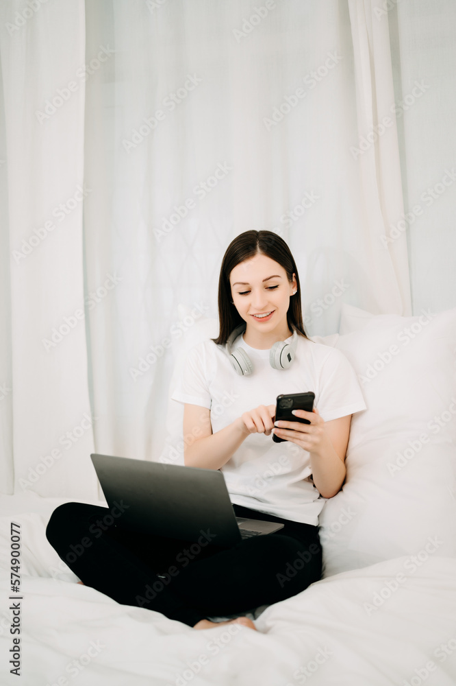 Beautiful woman has woken up on a white bed and holding coffee in the morning at home in morning