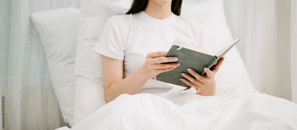 Good Healthy woman drinking tea and resting in white bed at bedroom. Lifestyle at home concept in mo