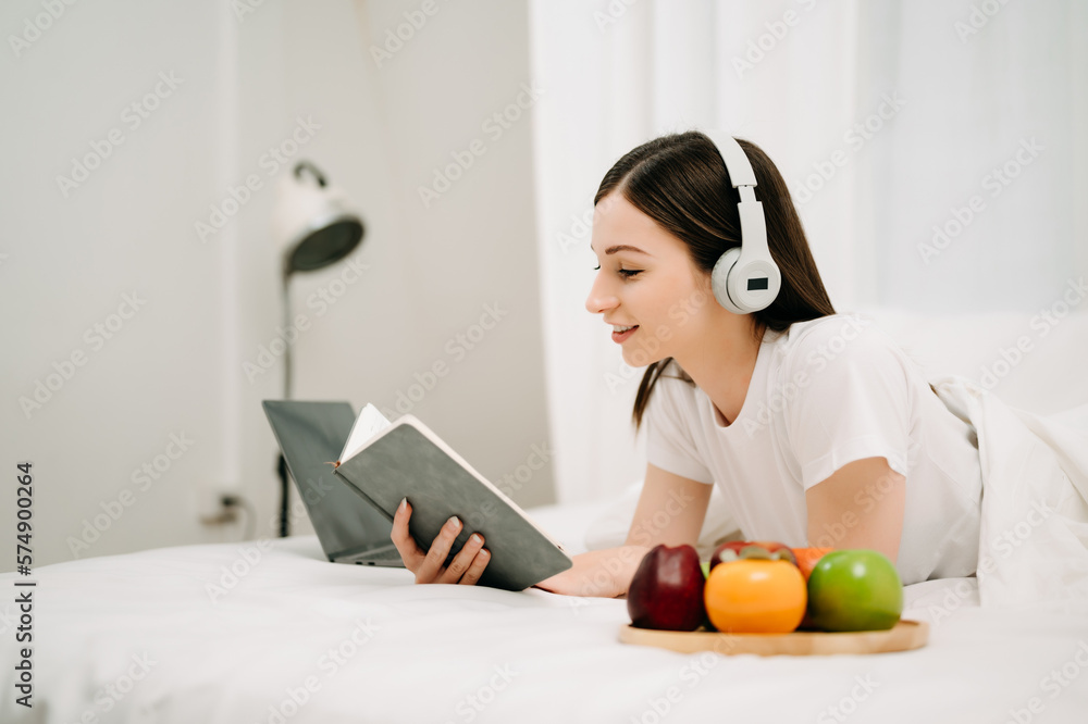 Portrait of Good Healthy young woman reading book and resting in bed at bedroom. lifestyle concept.