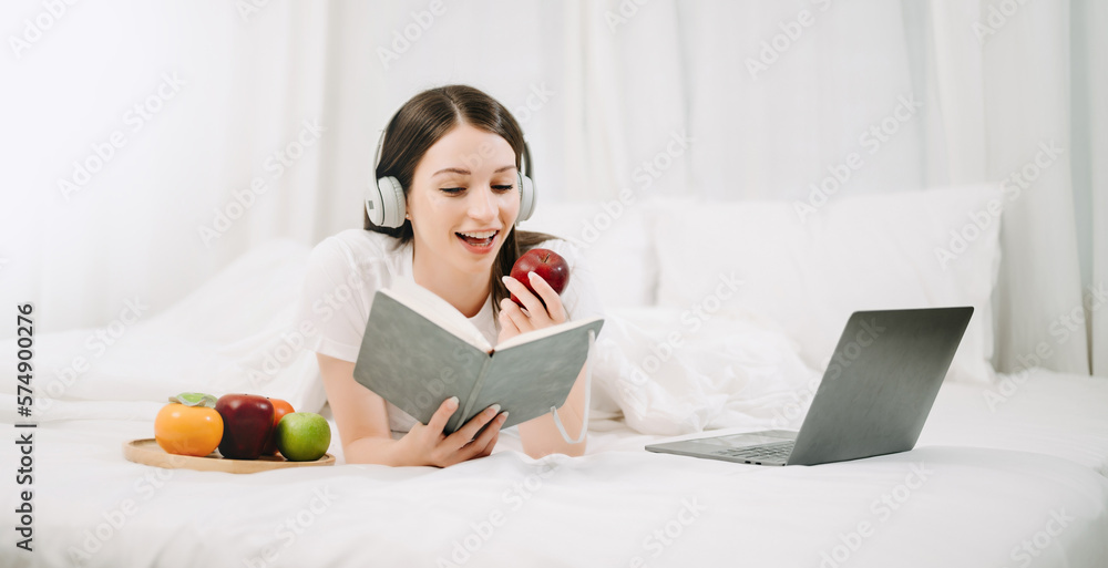 Portrait of Good Healthy young woman reading book and resting in bed at bedroom. lifestyle concept.