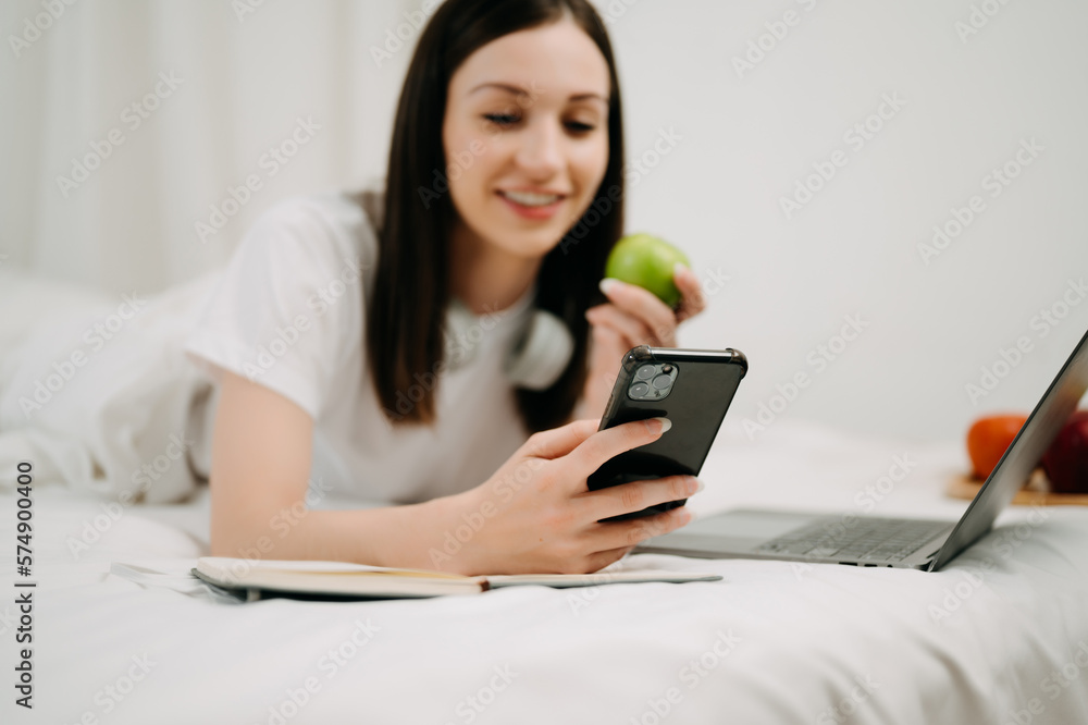 Beautiful woman resting and watching movie in bed at bedroom in morning Lifestyle at home