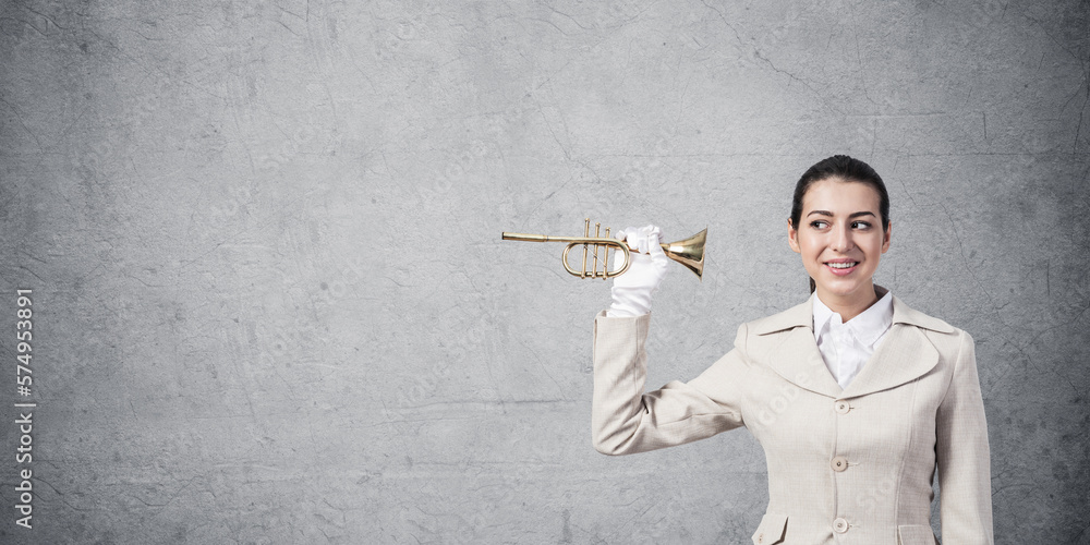 Beautiful woman holding trumpet brass near ear