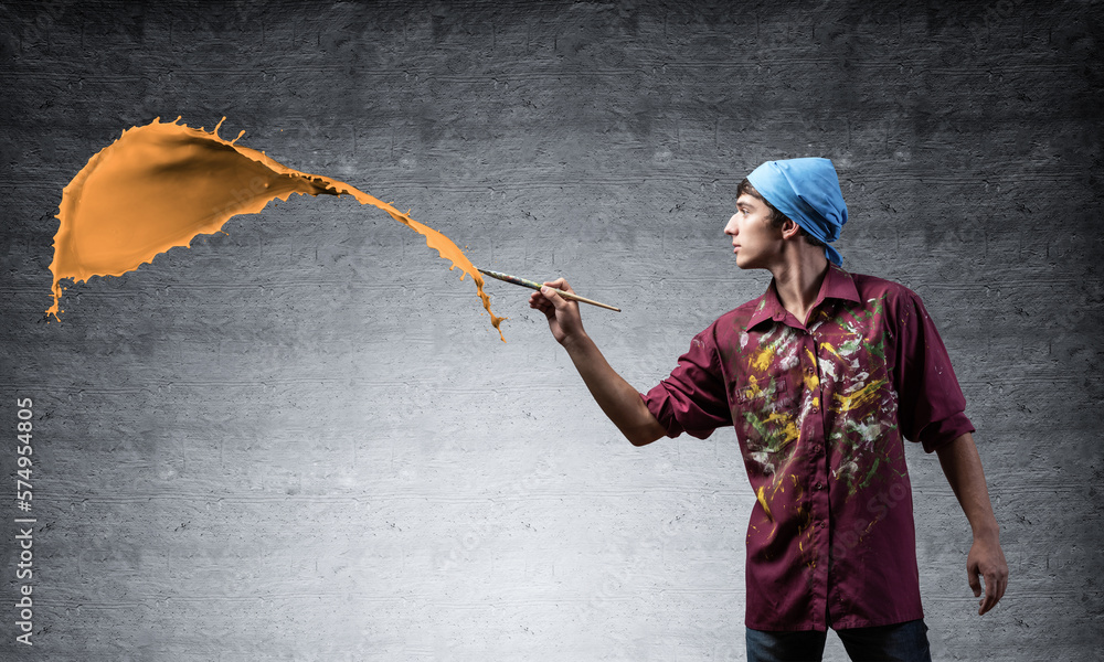 Young artist painting orange brush stroke