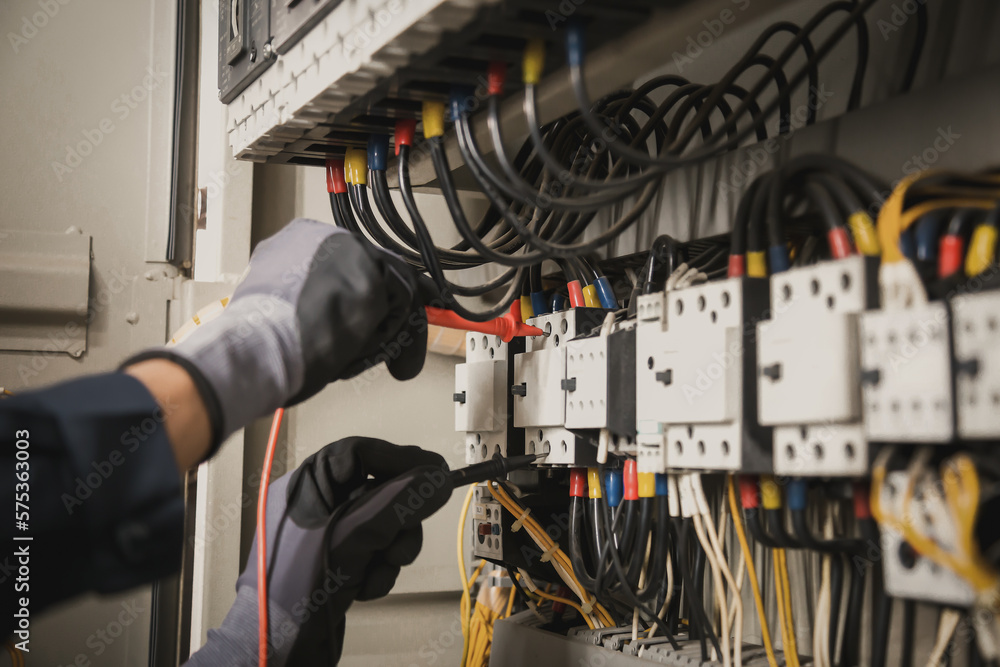 Electricity and electrical maintenance service, Engineer hand holding AC multimeter checking electri