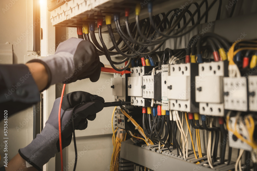 Electricity and electrical maintenance service, Engineer hand holding AC multimeter checking electri