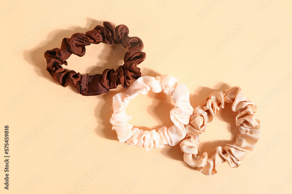 Stylish scrunchies on color background