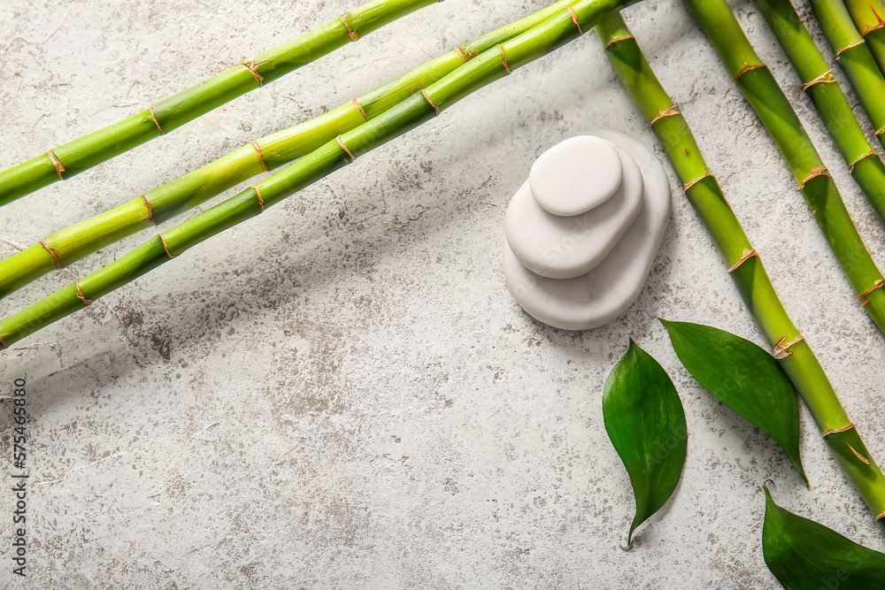 Spa stones and bamboo on light background, top view