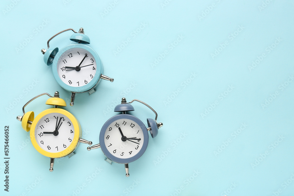 Alarm clocks on blue background