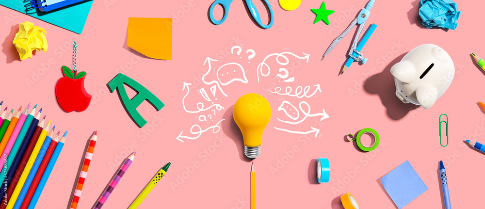 Brainstorming concept with a light bulb and school supplies - Flat lay