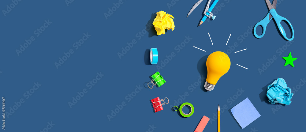 Idea light bulb with school supplies overhead view - flat lay