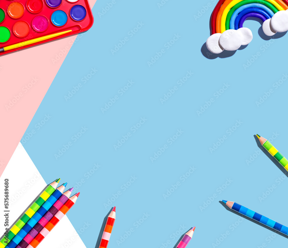 Art supplies with a rainbow - overhead view - flat lay