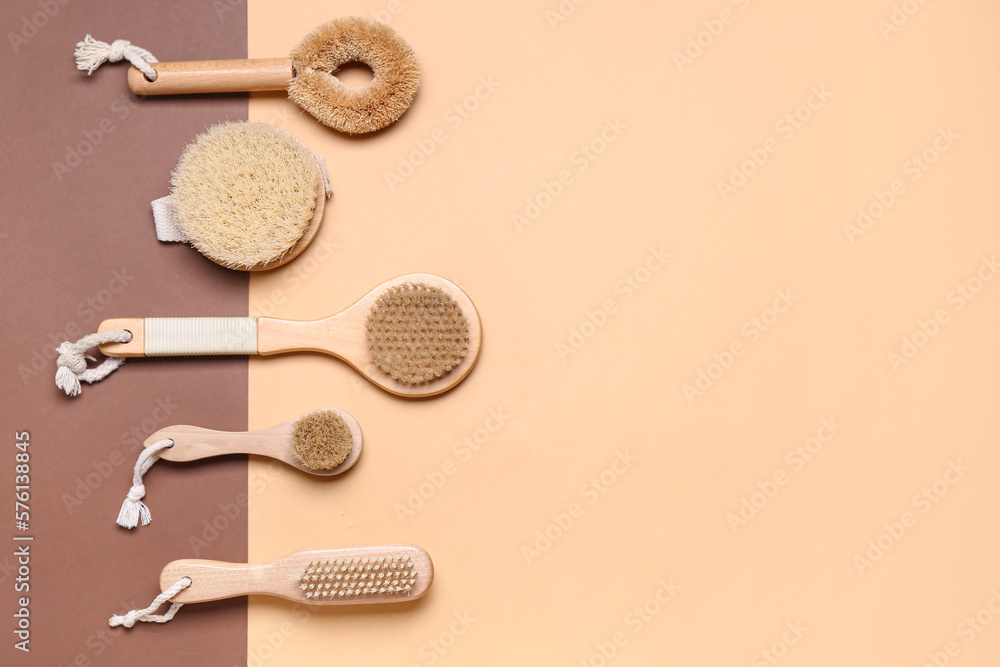 Set of different massage brushes on color background