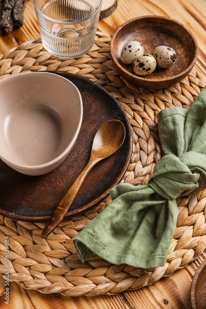 Beautiful table setting with plates, bowl and quail eggs on wooden background