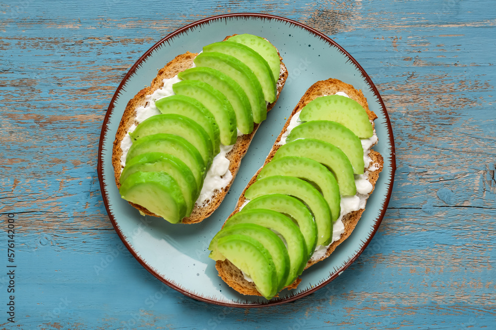 Delicious avocado toasts cheese on blue wooden background