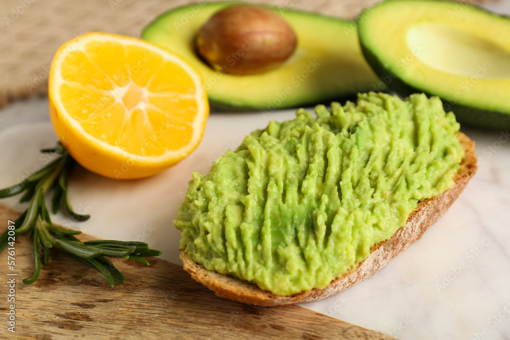 Delicious avocado toast on board, closeup