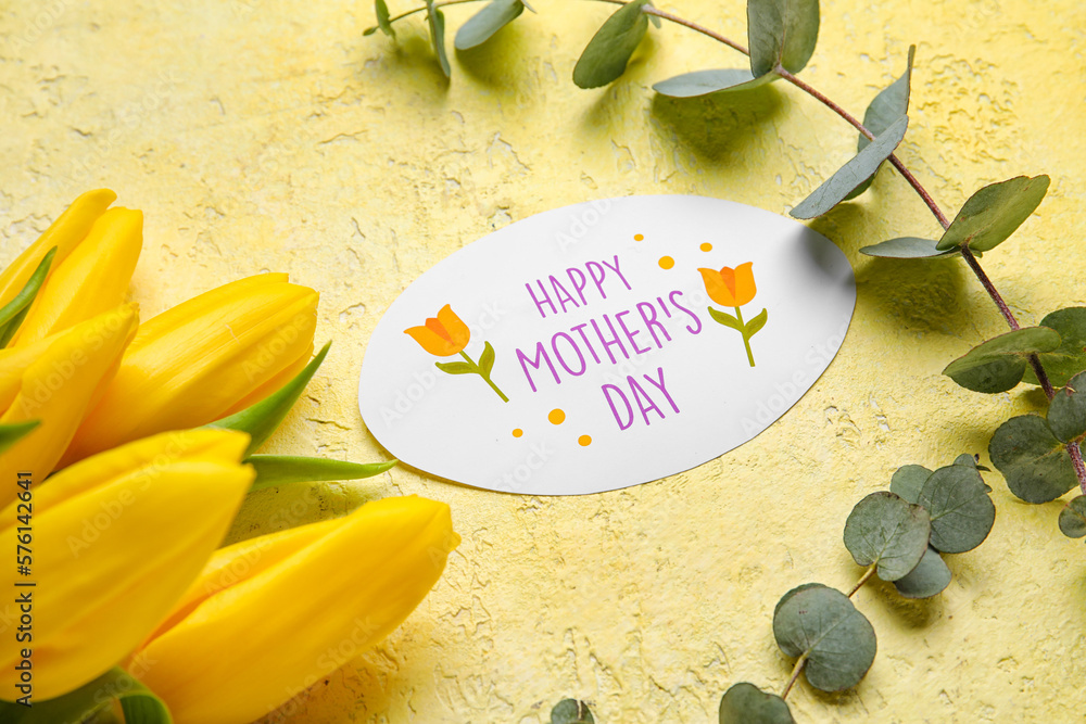 Card with text HAPPY MOTHERS DAY, beautiful tulip flowers and eucalyptus branches on yellow backgro