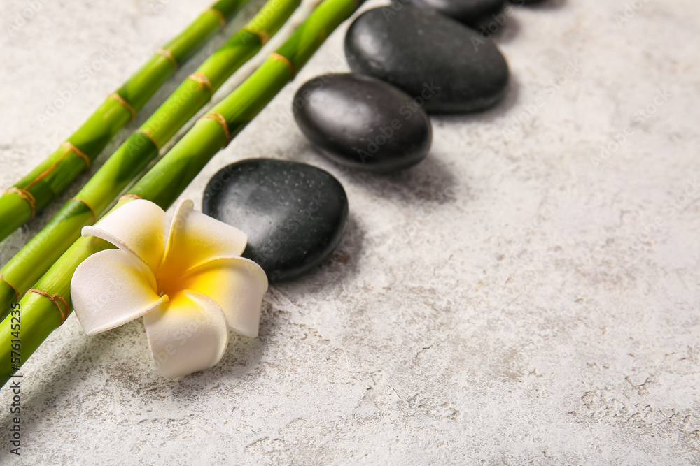 Spa stones, flower and bamboo on light background