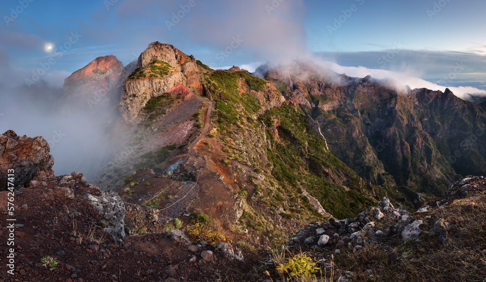 Mountain landscape at sunset in Madeira. Amazing view on colorful clouds and layered mountains.