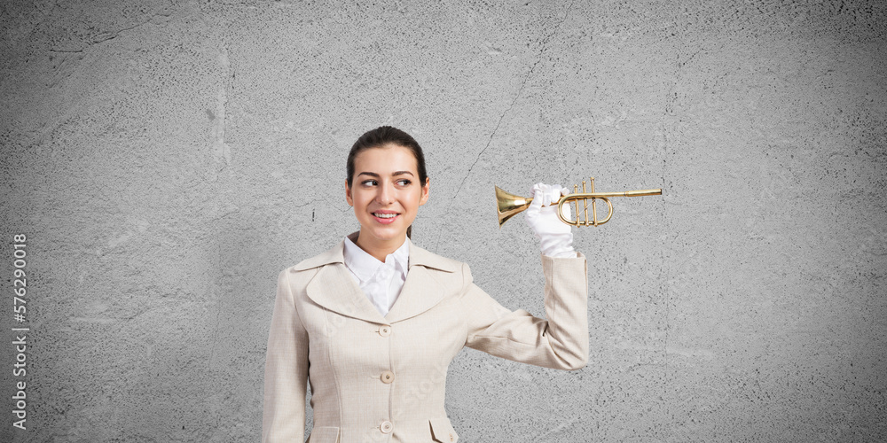 Beautiful woman holding trumpet brass near ear