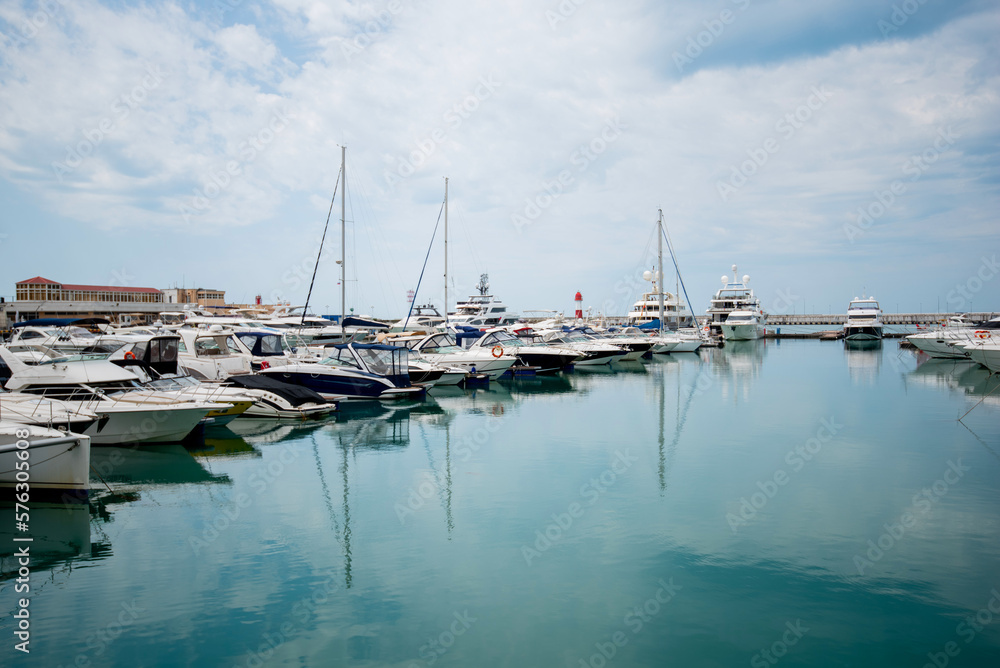 Yacht parking in harbor. Beautiful Yachts in blue sky background. Sailing harbor, many beautiful moo