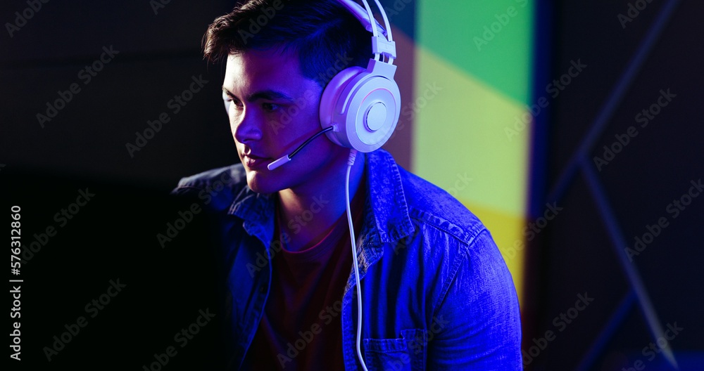 Male gamer playing a video game with a headset, engaging with online players and streamers