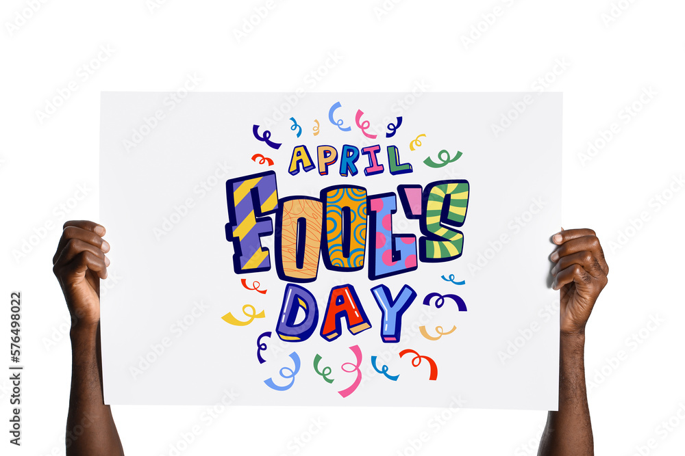 Hands of African-American man holding poster with text APRIL FOOLS DAY on white background