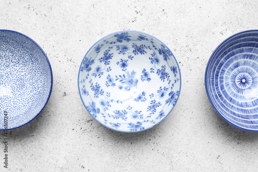 Set of different ceramic bowls on white background