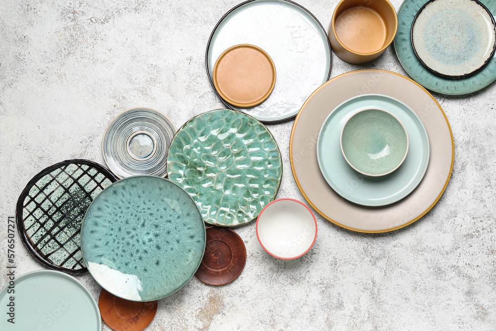 Composition with clean ceramic plates and bowls on white background