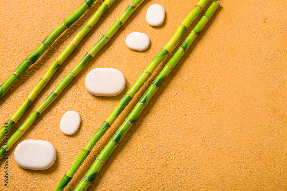 Spa stones and bamboo on beige background, top view