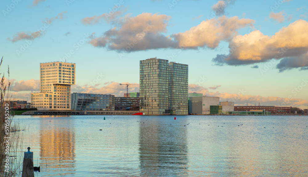 Waterfront city skyline with reflection in the lake at sunset, Almere, Flevoland, Netherlands