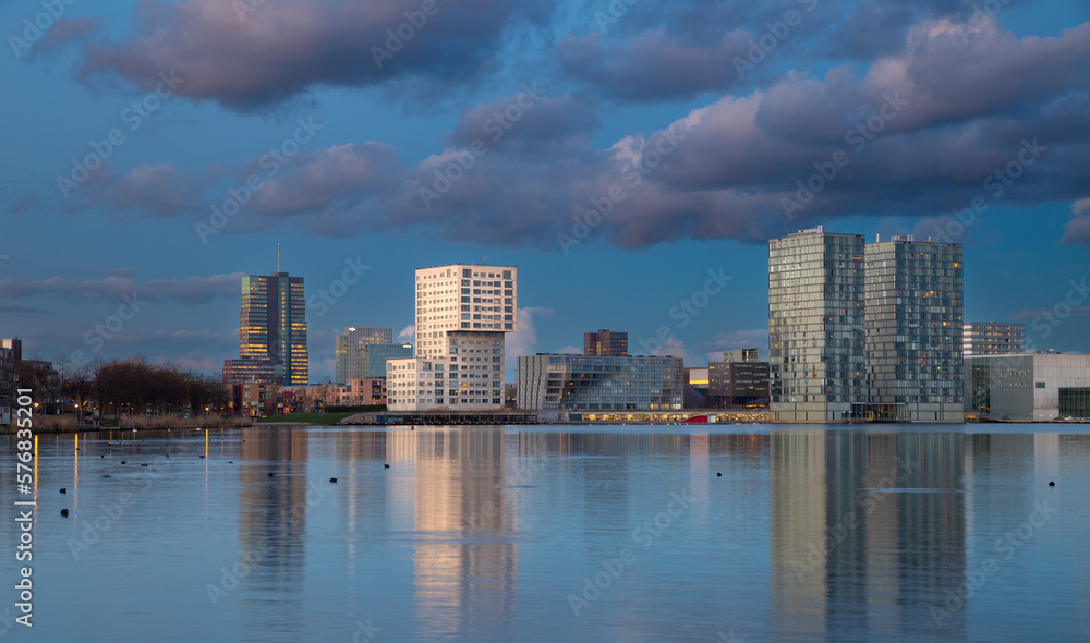 Waterfront city skyline with reflection in the lake at sunset, Almere, Flevoland, Netherlands